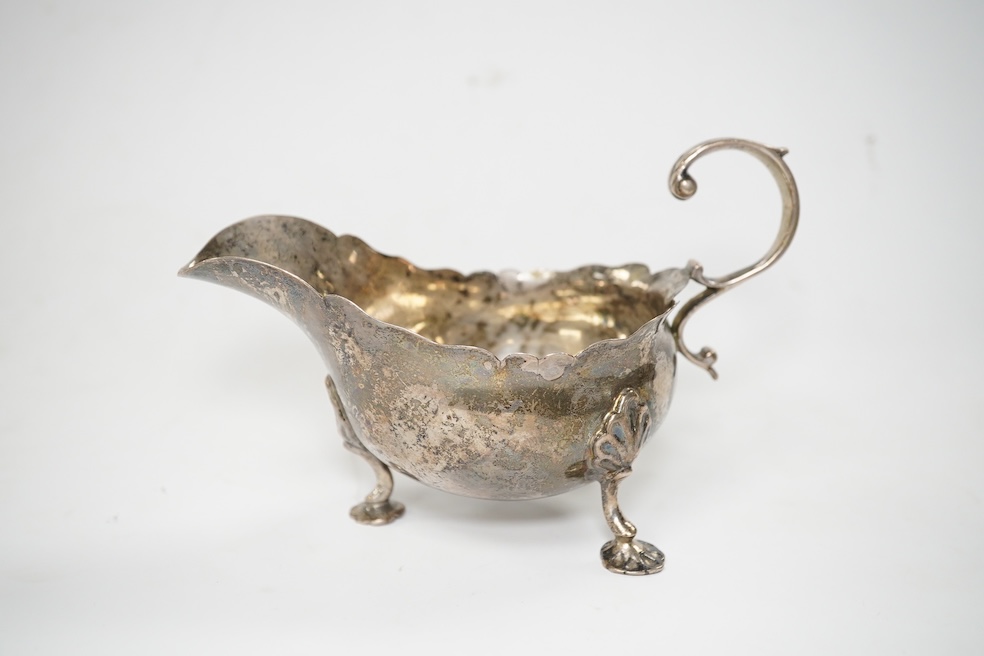 A Victorian silver sauce boat, London, 1876, length 14.2cm and metal quaich (adapted). Condition - poor to fair